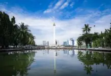 Cheap flights to Jakarta: Soekarno-Hatta, beating the traffic with the airport train, and the Bali connection The National Monument (Monas) and Jakarta skyline reflected in a pond