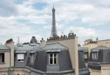 Haussmann rooftops of Paris with the Eiffel Tower rising behind them