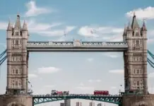 Tower Bridge over the Thames with a red double-decker bus crossing