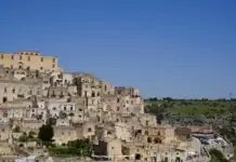 The sunlit stacked stone houses of the Sassi di Matera above the Gravina ravine