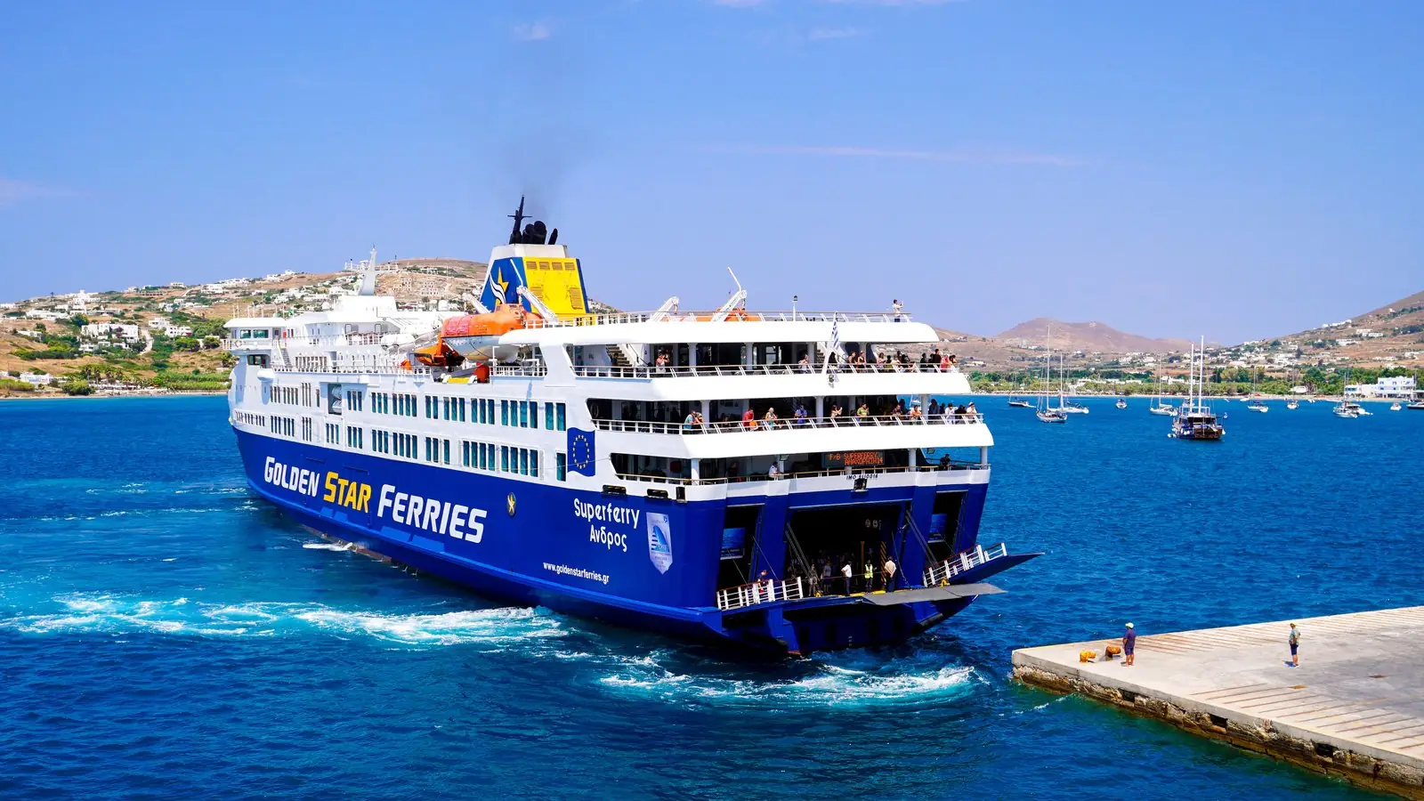 A Golden Star ferry loading at an island pier in the Cyclades