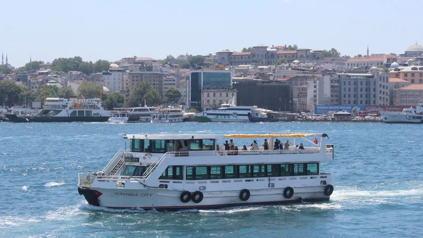 A passenger ferry crossing the Bosphorus with the Istanbul skyline behind