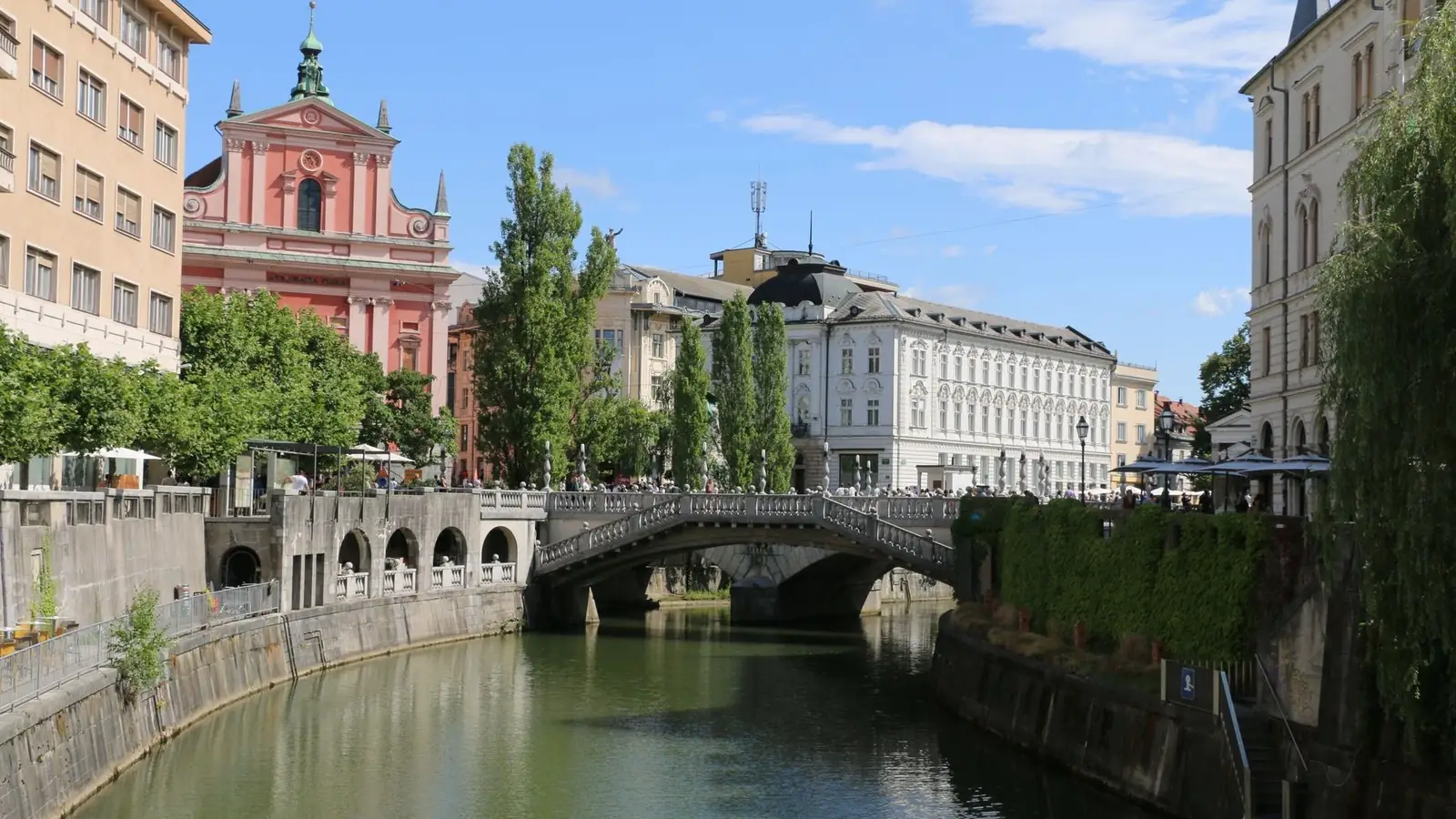 The Triple Bridge over the Ljubljanica with the pink Franciscan church in Ljubljana
