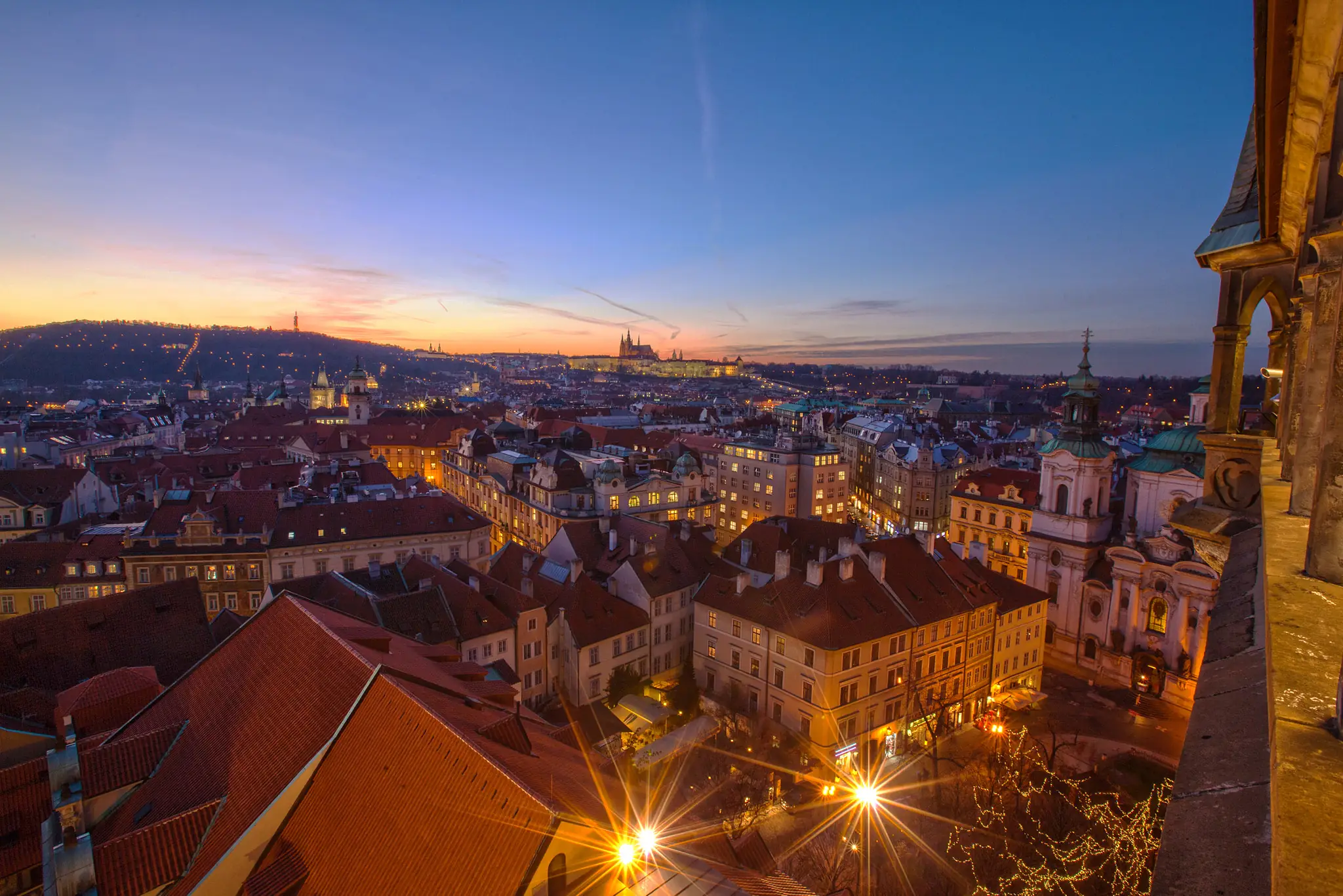 Old Town rooftops and Prague Castle at dusk