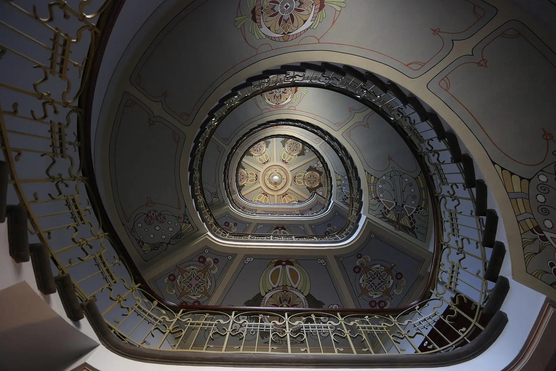 Painted spiral staircase of the Riga Art Nouveau Centre seen from below