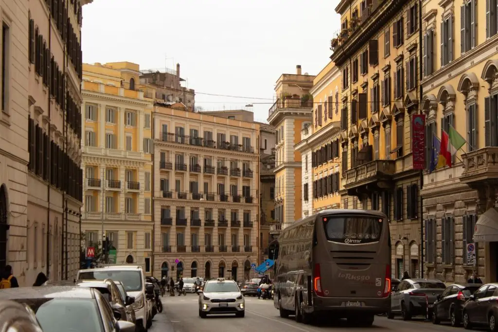 A white official taxi on a street in the Monti district of Rome