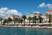 The palm-lined Riva waterfront promenade in Split with Diocletian's Palace behind