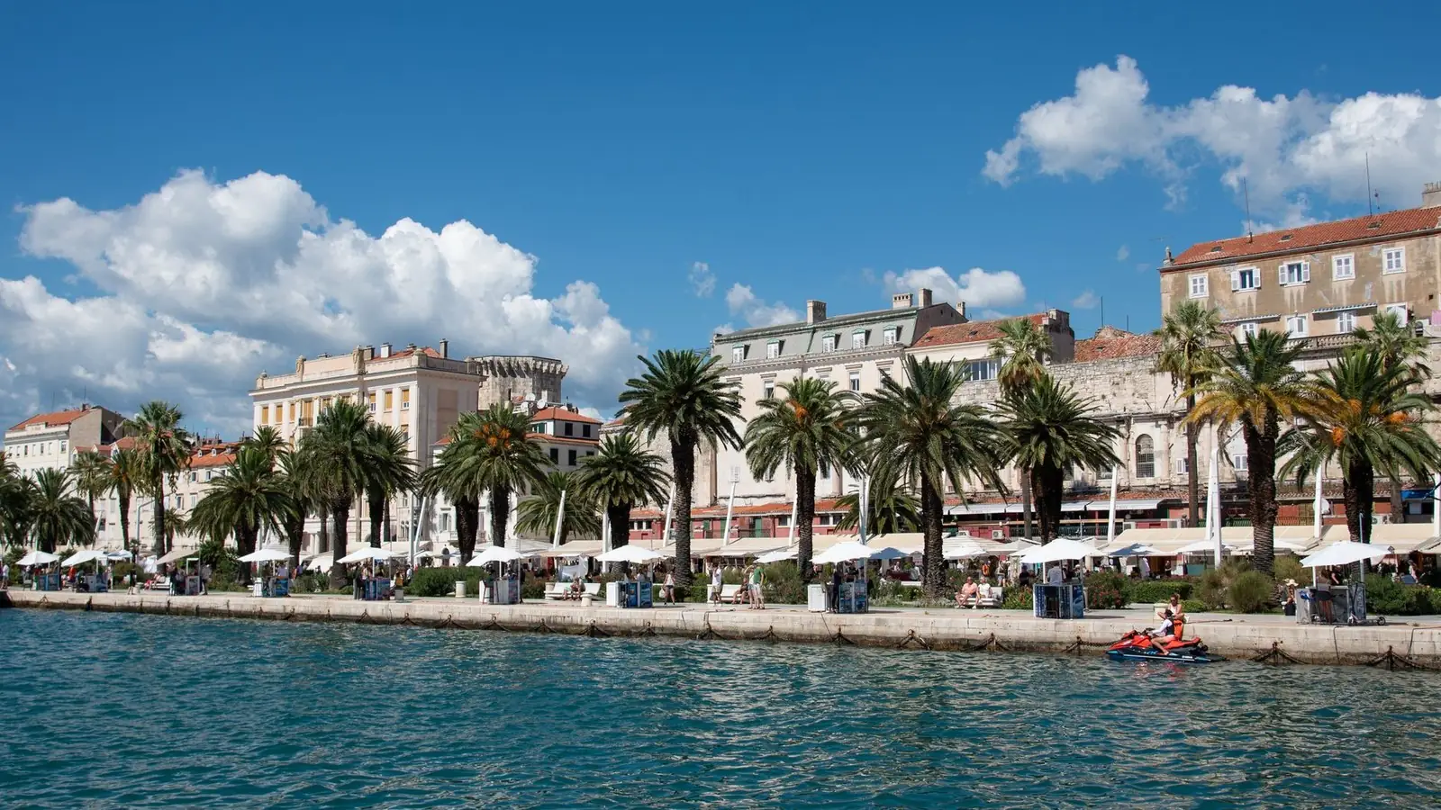 The palm-lined Riva waterfront promenade in Split with Diocletian's Palace behind