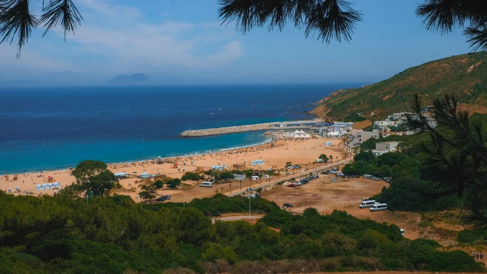 The bright Tangier coast, with the Spanish shore faint across the Strait of Gibraltar