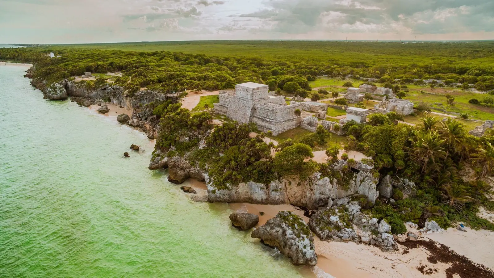 Aerial view of the Tulum Mayan ruins on a clifftop above the turquoise Caribbean Sea