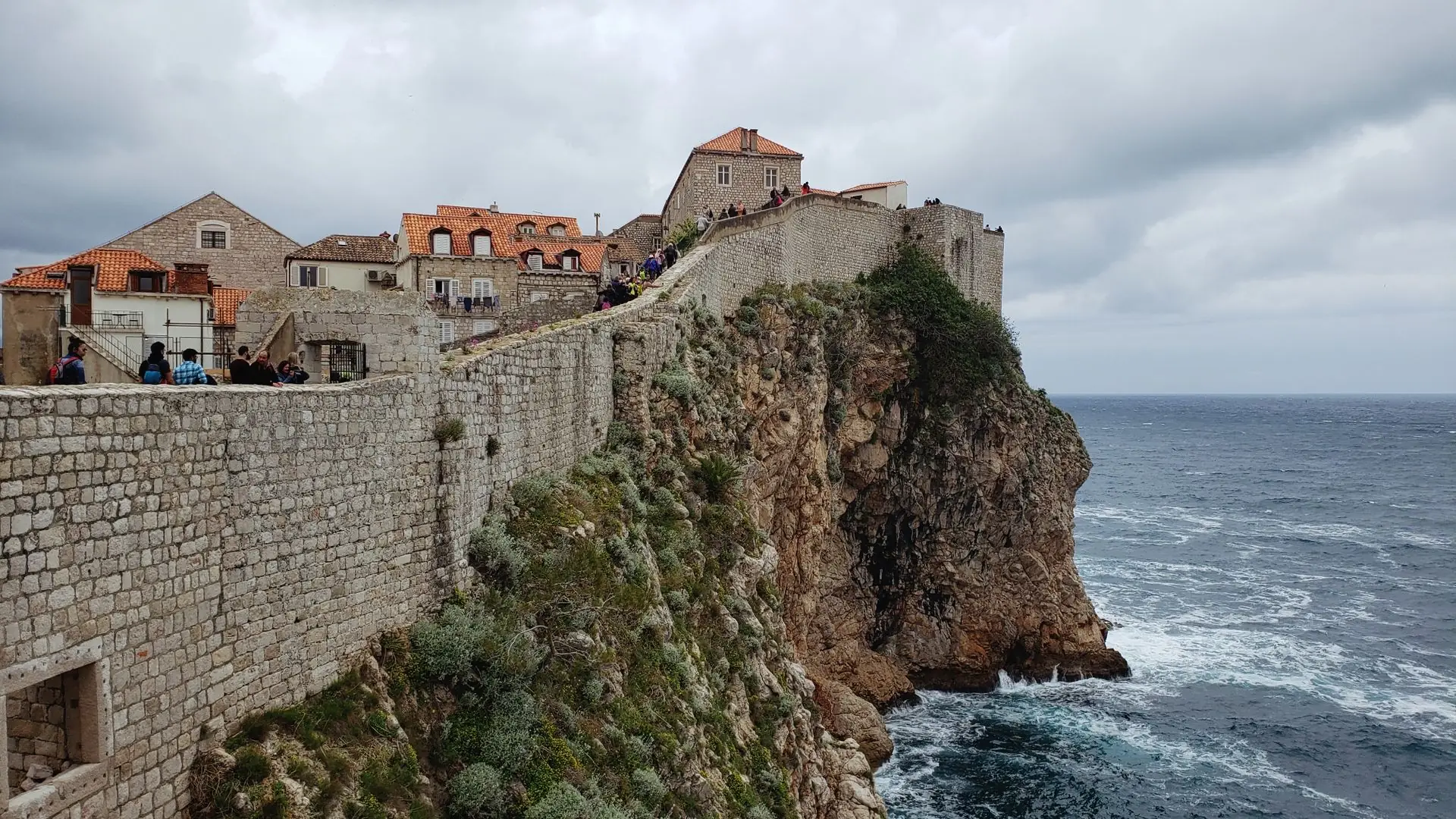 The Reality of Dubrovnik: The Republic of Libertas Dubrovnik city walls on the cliff above the Adriatic Sea