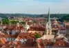 The Reality of Prague: The City the Bombs Missed — and What a Real Centre Costs Historic red rooftops of Prague with castle and river beyond