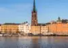 Cheap flights to Stockholm: three airports wearing one name, the 18-minute train, and when the light comes back Riddarholmen waterfront and church spire across the water, Stockholm